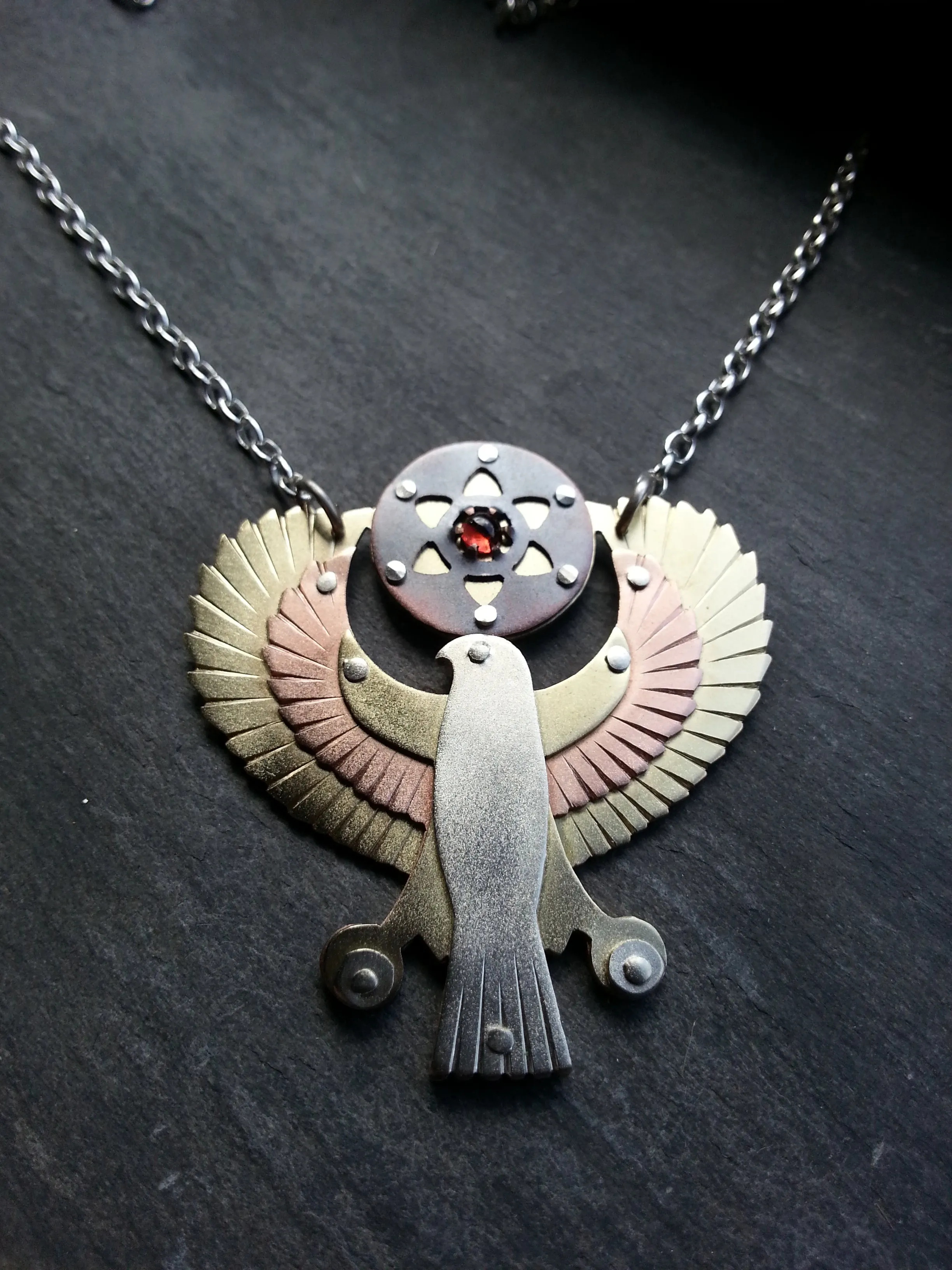 Handcut Egyptian Horus Pendant - holding seed of life red garnet